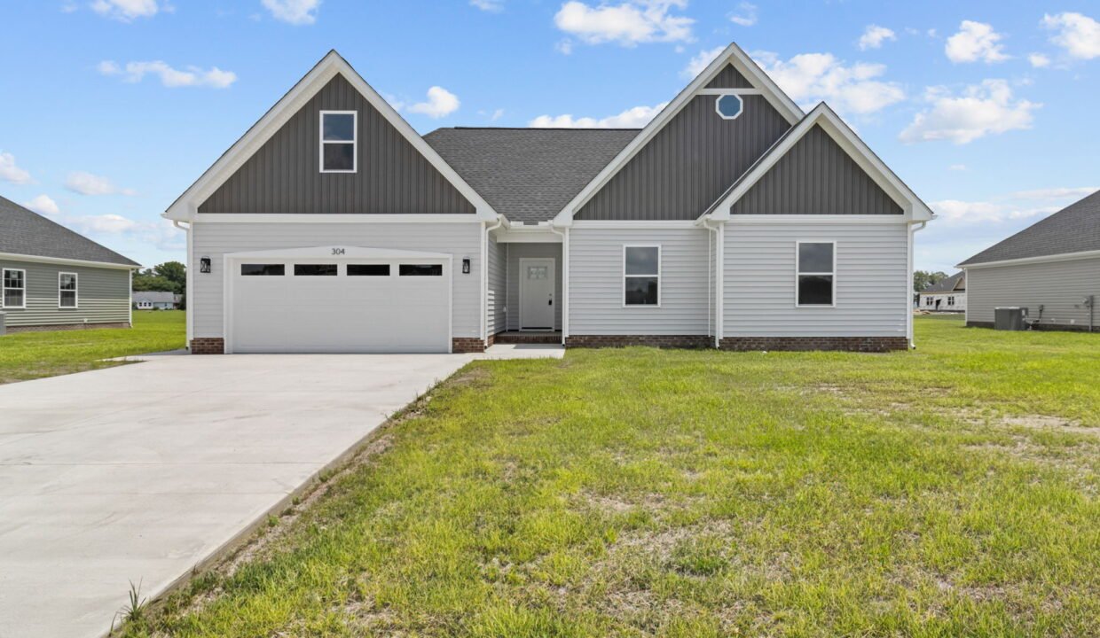 The Vanity II model home by HomeLink in Tooley Harbor, Elizabeth City, NC. A single-story, 3-bedroom new construction home with gray siding and a 2-car garage.