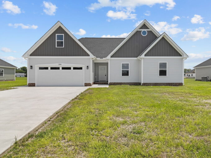 The Vanity II model home by HomeLink in Tooley Harbor, Elizabeth City, NC. A single-story, 3-bedroom new construction home with gray siding and a 2-car garage.