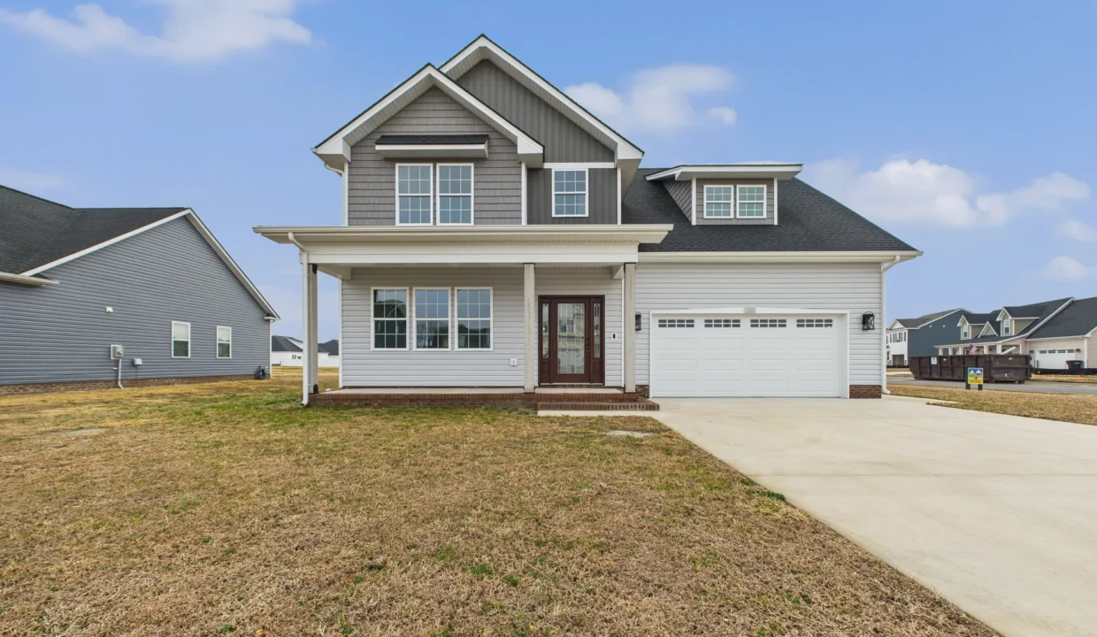 Exterior view of The San Lucas, a gray two-story new construction house with a white garage in Elizabeth City, NC.