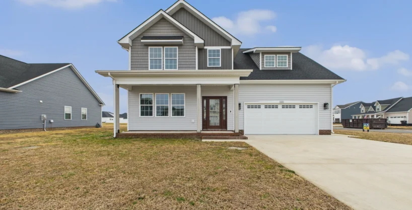 Exterior view of The San Lucas, a gray two-story new construction house with a white garage in Elizabeth City, NC.